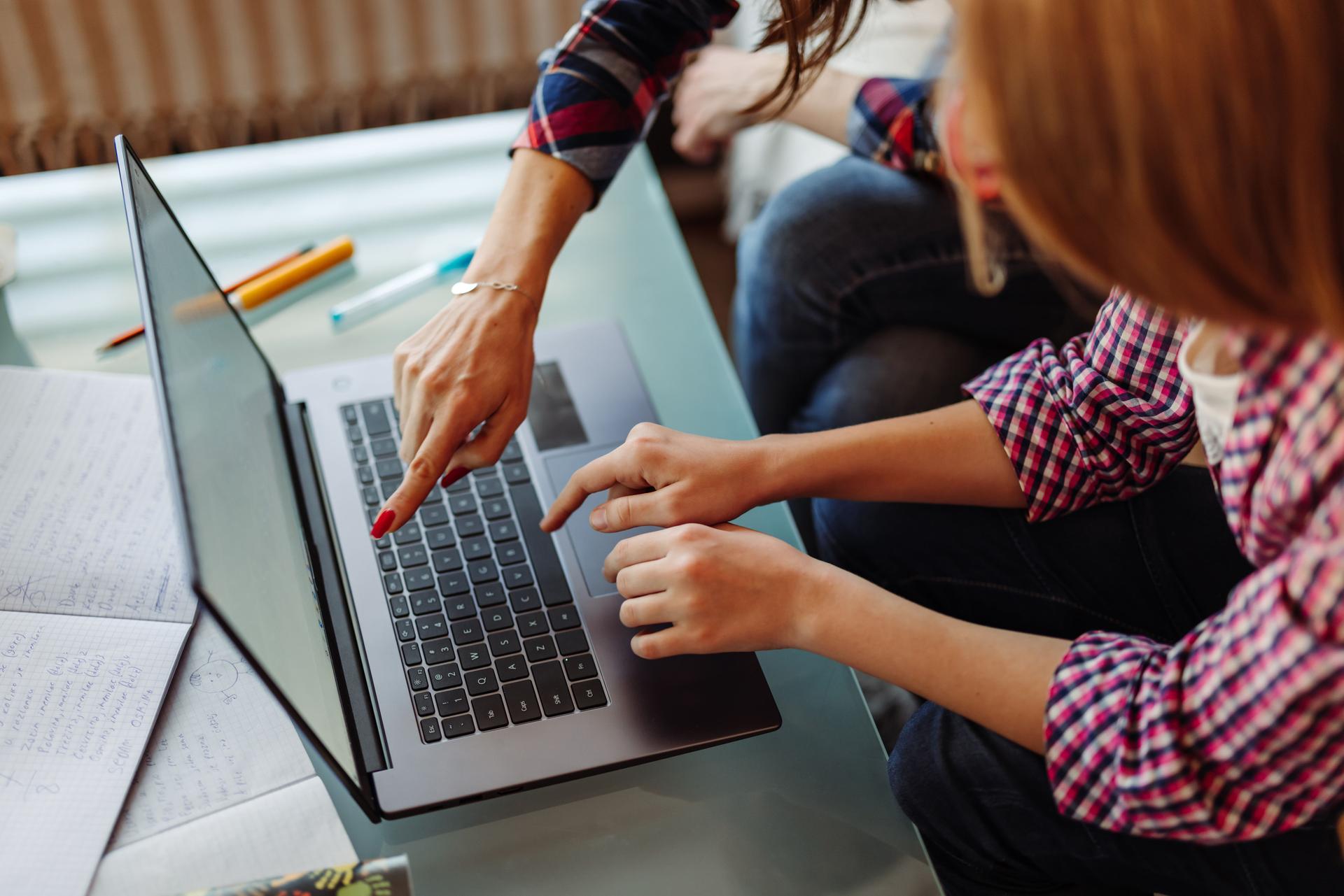 Mother and daughter studying with laptop on a online class at home